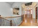 Bright foyer featuring hardwood floors, rod iron railings, and open floor plan at 5149 Raintree Dr, Parker, CO 80134