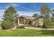 Charming home featuring stone accents, a well-manicured lawn, and flowering plants creating an inviting curb appeal at 5149 Raintree Dr, Parker, CO 80134