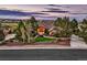 Beautiful home with lush landscaping, mature trees, a red front door, and a view of the golf course and neighborhood at 5149 Raintree Dr, Parker, CO 80134