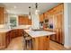 Modern kitchen with wood cabinets, a large island, stainless steel appliances, and pendant lighting at 5149 Raintree Dr, Parker, CO 80134