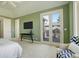 This main bedroom features a large window/door combo leading to a private balcony, and tv at 5149 Raintree Dr, Parker, CO 80134