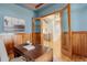 Home office with hardwood floors, french doors and views into the hallway with wood stairs at 5149 Raintree Dr, Parker, CO 80134