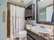 Charming bathroom featuring a floral shower curtain, vanity with granite top, and neutral colored walls at 5133 E Essex Ave, Castle Rock, CO 80104