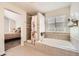 Bathroom featuring a soaking tub, a shower, tile backsplash, and great natural light at 5133 E Essex Ave, Castle Rock, CO 80104