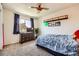 Bedroom with airplane-themed bedding, a ceiling fan, window with curtains, and a dresser with a TV at 5133 E Essex Ave, Castle Rock, CO 80104