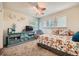 Bedroom with floral bedding, a ceiling fan, and bright natural light from multiple windows at 5133 E Essex Ave, Castle Rock, CO 80104