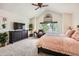 Bright primary bedroom with vaulted ceilings, ceiling fan, sitting area, and plush carpet at 5133 E Essex Ave, Castle Rock, CO 80104