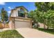 Two-story house with large arched window over the garage and large driveway at 5133 E Essex Ave, Castle Rock, CO 80104