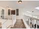 Hallway with carpet flooring, white railings, accent artwork, and great lighting at 5133 E Essex Ave, Castle Rock, CO 80104