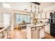Well-lit kitchen showcasing a center island with granite countertops and stainless steel appliances at 5133 E Essex Ave, Castle Rock, CO 80104