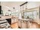 Bright kitchen with island, granite countertops, stainless steel appliances, and hardwood floors at 5133 E Essex Ave, Castle Rock, CO 80104