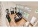High-angle view of a living room with a fireplace, high ceilings, and plenty of natural light at 5133 E Essex Ave, Castle Rock, CO 80104