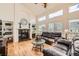 Spacious living room with high ceilings, a cozy fireplace, and large windows for ample sunlight at 5133 E Essex Ave, Castle Rock, CO 80104