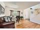 Bright living room with hardwood floors, stylish furnishings, a large window, and white trim at 5133 E Essex Ave, Castle Rock, CO 80104