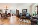 Open-concept living room with hardwood floors, ample seating, and a dining area at 5133 E Essex Ave, Castle Rock, CO 80104