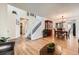 Spacious living area with hardwood floors, open staircase, and dining area at 5133 E Essex Ave, Castle Rock, CO 80104