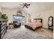 Serene main bedroom with vaulted ceilings, large windows, and a comfortable sitting area at 5133 E Essex Ave, Castle Rock, CO 80104