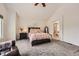 Comfortable main bedroom with neutral tones, a vaulted ceiling, and an attached bathroom at 5133 E Essex Ave, Castle Rock, CO 80104