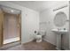 This bathroom features a pedestal sink, a walk-in shower, and neutral walls and flooring at 708 Teal Cir, Longmont, CO 80503