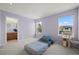 Bedroom with light purple walls, carpet and view of the neighborhood through windows at 708 Teal Cir, Longmont, CO 80503