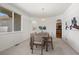 Bright dining room with a modern table and chairs, complemented by a stylish chandelier and ample natural light at 708 Teal Cir, Longmont, CO 80503