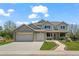 Charming two-story home featuring a landscaped front yard, gray brick, and an attached two-car garage at 708 Teal Cir, Longmont, CO 80503