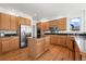 Bright kitchen boasting an island, stainless steel appliances, and hardwood flooring at 708 Teal Cir, Longmont, CO 80503