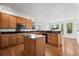 Well-lit kitchen with stainless steel appliances, center island, and hardwood floors at 708 Teal Cir, Longmont, CO 80503