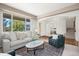 Cozy living room with large windows, a plush sofa, and stylish decor offering a comfortable and inviting space at 708 Teal Cir, Longmont, CO 80503