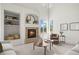 Bright living room featuring a fireplace, large windows, and built-in shelving offering a comfortable and stylish living space at 708 Teal Cir, Longmont, CO 80503
