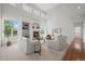 Spacious living room with high ceilings, a cozy fireplace, built-in shelves, and an abundance of natural light at 708 Teal Cir, Longmont, CO 80503