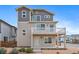 Charming two-story home featuring a balcony, landscaped front yard, and modern design elements at 46570 Avery Ln, Bennett, CO 80102