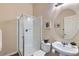Well-lit bathroom featuring a glass-enclosed shower and pedestal sink at 6216 E 135Th Ave, Thornton, CO 80602