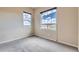 Cozy bedroom with gray carpet and natural light from two windows at 6216 E 135Th Ave, Thornton, CO 80602