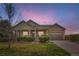 Charming front exterior of the home with manicured bushes and grassy front lawn at 6216 E 135Th Ave, Thornton, CO 80602