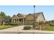 Inviting single-story home featuring a stone and siding exterior, a covered porch, and a well-manicured lawn at 6216 E 135Th Ave, Thornton, CO 80602