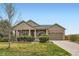 Charming single-story home with a stone and siding facade, complemented by a well-maintained lawn and landscaping at 6216 E 135Th Ave, Thornton, CO 80602