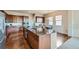A large kitchen island features a granite countertop with wood cabinets and stainless steel appliances at 6216 E 135Th Ave, Thornton, CO 80602