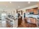 Open kitchen with granite countertops, a center island with seating, and stainless steel appliances, ideal for entertaining at 6216 E 135Th Ave, Thornton, CO 80602
