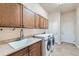 Laundry room with sink, counter, and cabinets above the washer and dryer at 6216 E 135Th Ave, Thornton, CO 80602