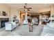 Open-concept living space showcasing a fireplace, neutral tones, and seamless flow into the kitchen and dining areas at 6216 E 135Th Ave, Thornton, CO 80602