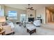 Bright living room with neutral decor, a fireplace, large windows, and a sliding glass door to the outdoor space at 6216 E 135Th Ave, Thornton, CO 80602