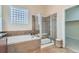 The main bathroom offers a shower, a soaking tub, and tile floors at 6216 E 135Th Ave, Thornton, CO 80602