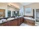 The main bathroom offers double sinks, granite countertops, and a separate shower and tub at 6216 E 135Th Ave, Thornton, CO 80602