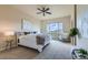 A serene main bedroom featuring a large window and a calm, neutral color scheme at 6216 E 135Th Ave, Thornton, CO 80602