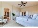 A spacious main bedroom with an en-suite bathroom, a walk-in closet, and neutral decor at 6216 E 135Th Ave, Thornton, CO 80602