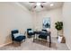 Cozy office furnished with an elegant desk, two blue chairs, and a neutral color palette at 6216 E 135Th Ave, Thornton, CO 80602