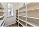 Pantry with floor to ceiling open shelves and a window to the exterior at 6216 E 135Th Ave, Thornton, CO 80602