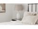 Comfortable bedroom with a neutral color palette, featuring a cozy bed with plush pillows and a side table at 117 S Pierce St, Lakewood, CO 80226