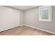 A simple bedroom featuring vinyl floors, a window, and a closet with sliding doors at 117 S Pierce St, Lakewood, CO 80226